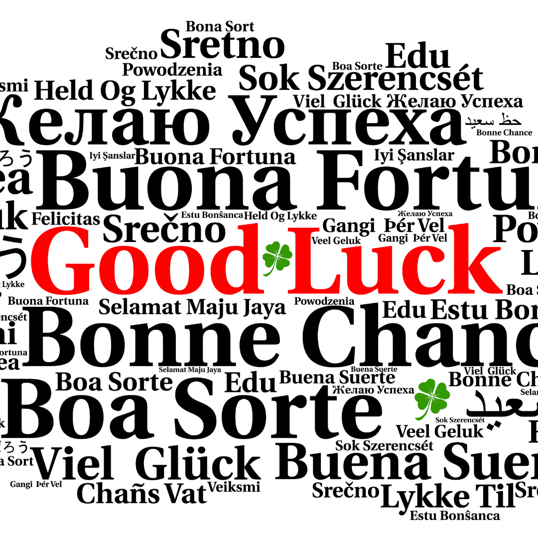 Word cloud featuring 'Good Luck' in red and various other languages with a green clover.